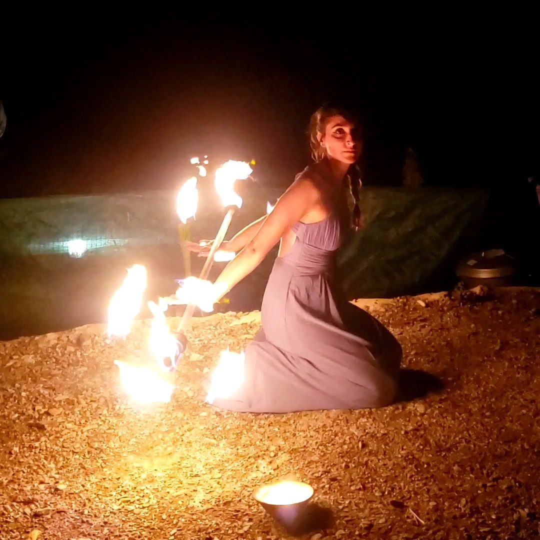 Maka performing with dragon stuff in her back. The outfit is a long dress. Beautiful fire dancing show!